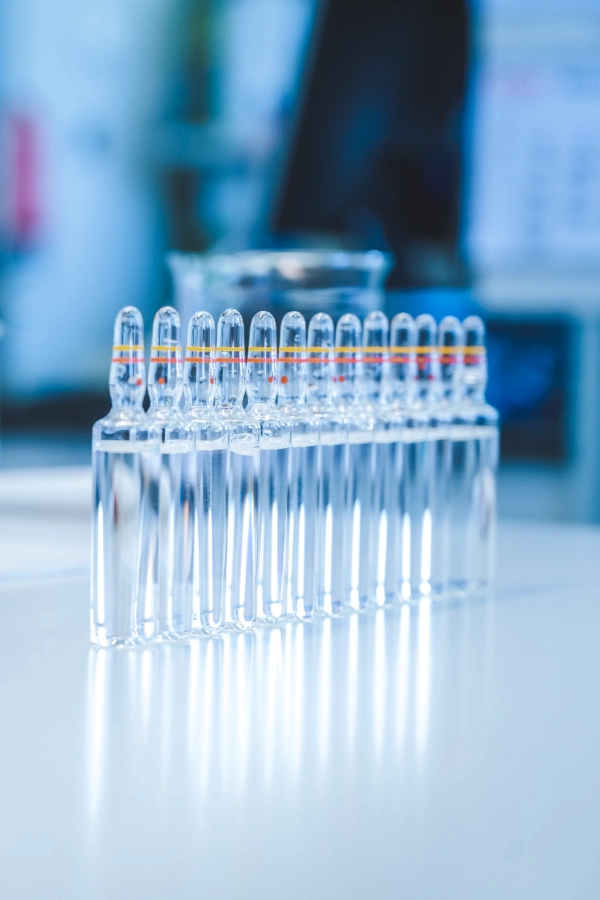 Glass ampoules with pharmaceutical solution in a Kalceks laboratory