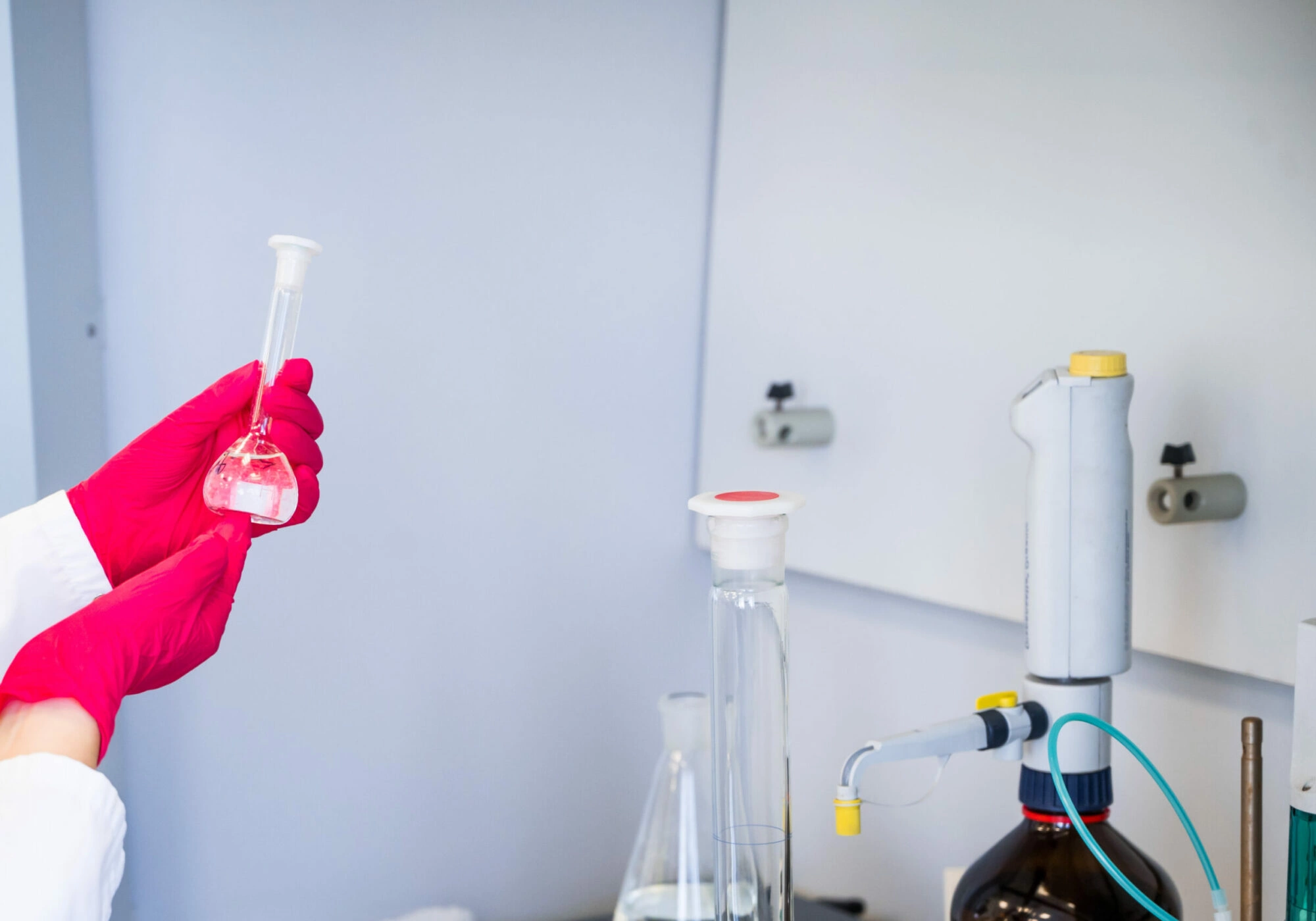 Pharmaceutical laboratory researcher holding a glass flask