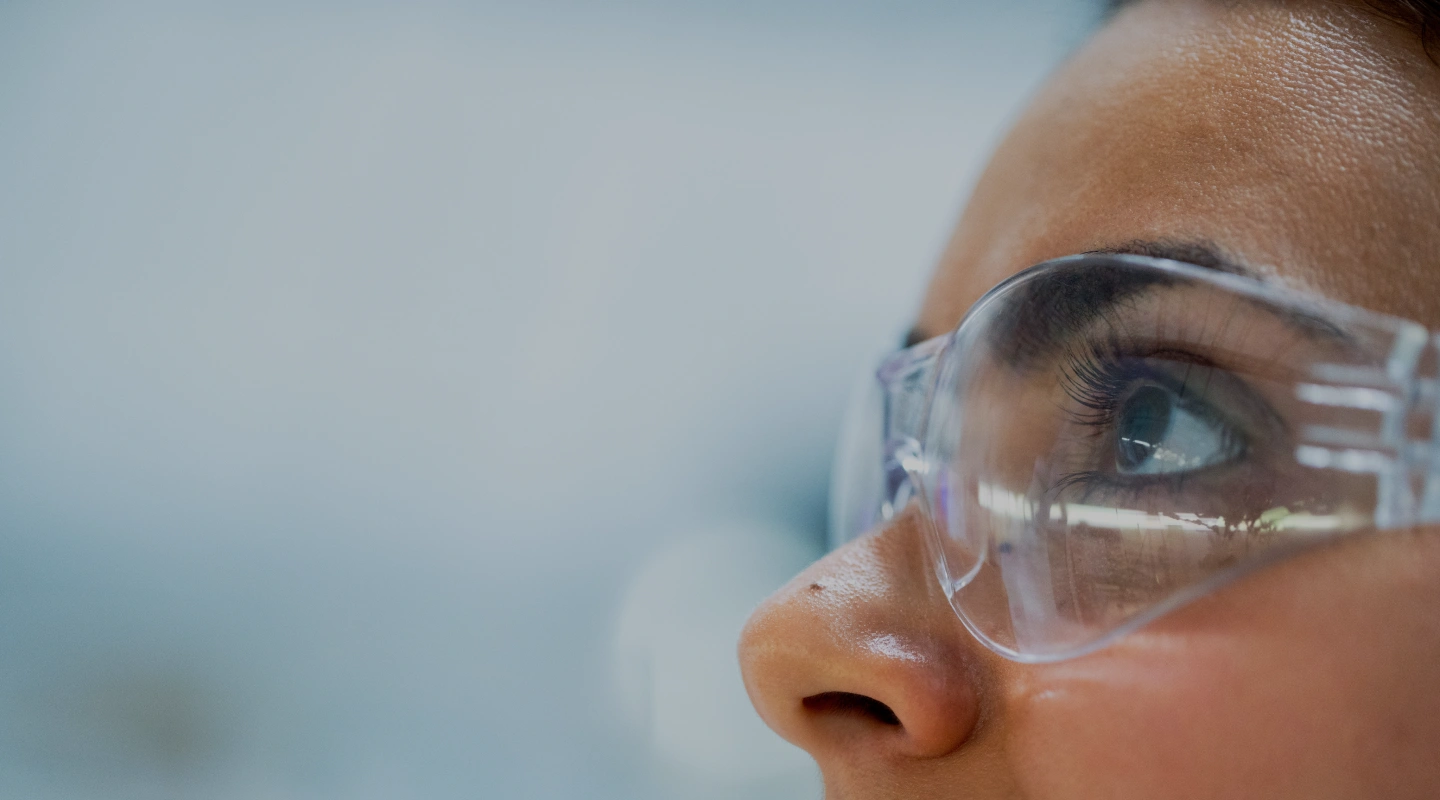 Pharmaceutical researcher wearing safety goggles in a Kalceks laboratory