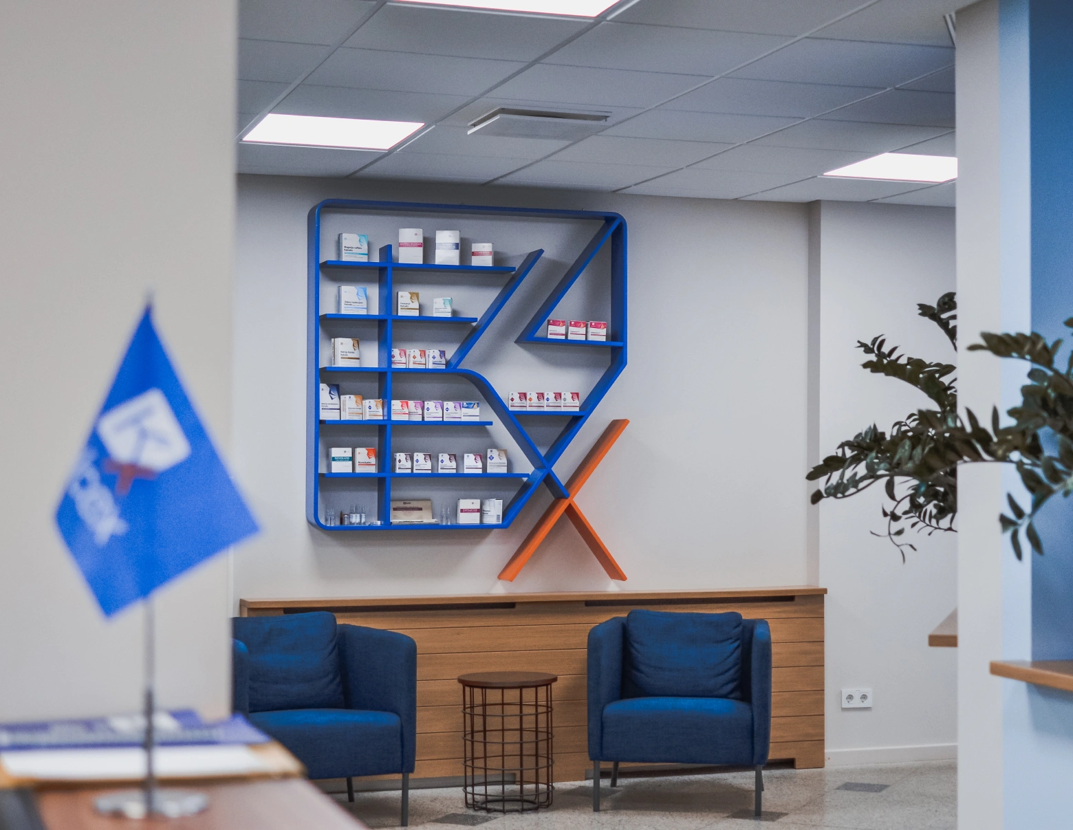 Kalceks office waiting room with chairs and Kalceks logo as decorative shelf
